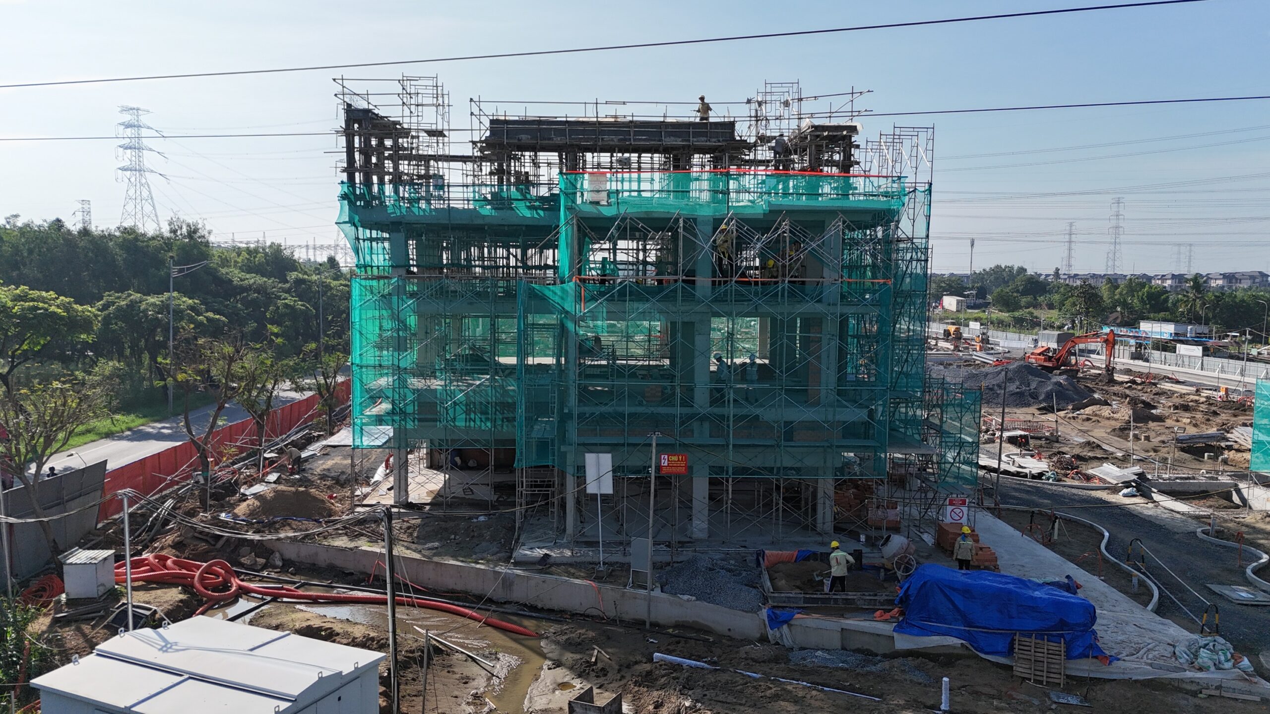 Slider Zone 1: Mockup Shophouses C.01 and C.02 are under construction with concrete works at top floors and brick works at Levels 1 & 2.