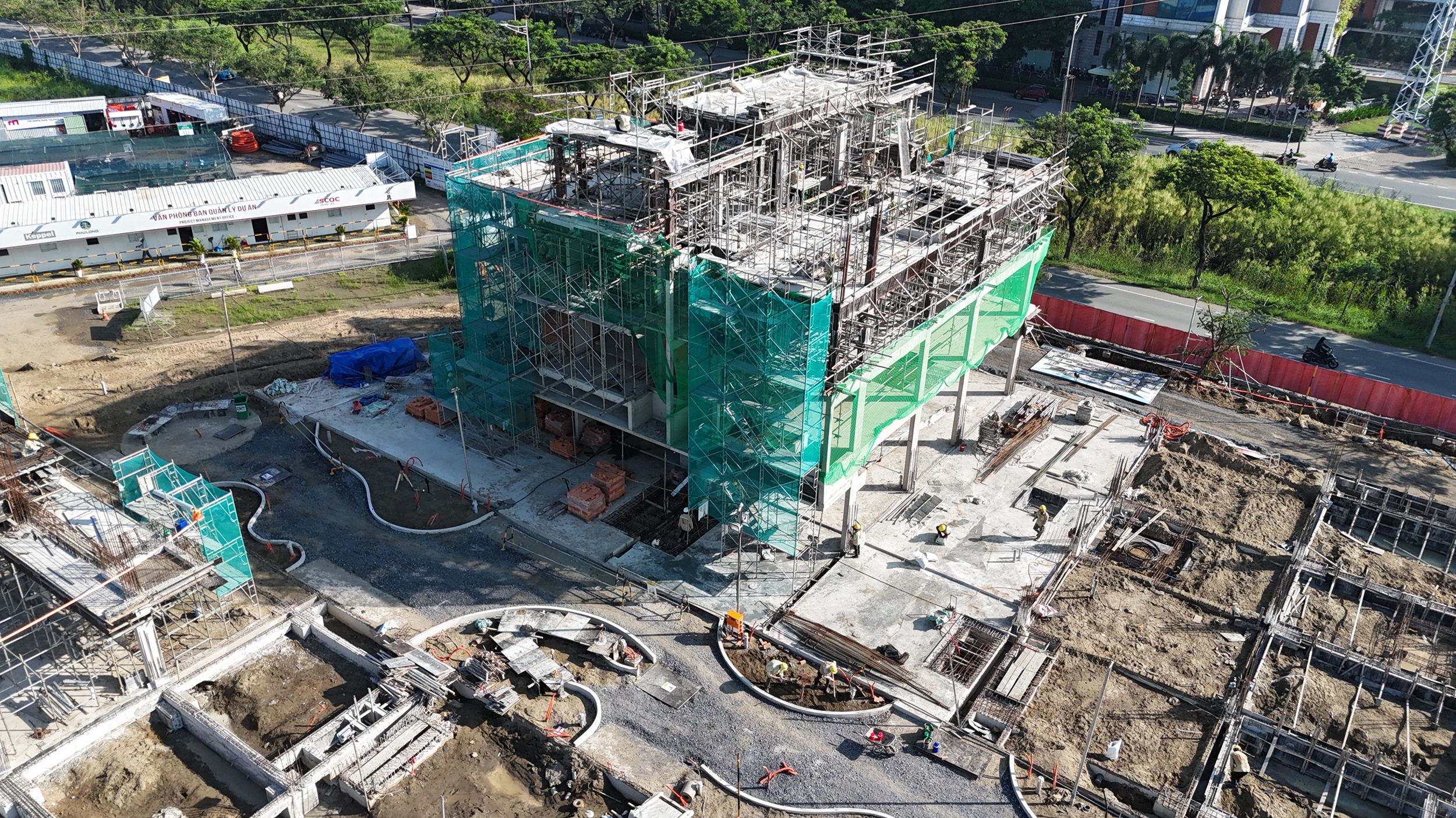 Slider Zone 1: Mockup Shophouses C.01 and C.02 are under construction with concrete works at top floors and brick works at Levels 1 & 2.